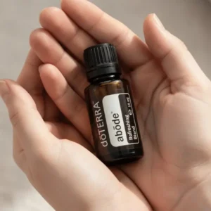 Dłonie trzymające Abode doTERRA – aplikacja olejku