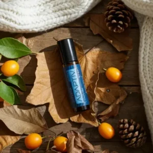 Adaptiv Touch doTERRA na jesiennej dekoracji z liśćmi i szyszkami