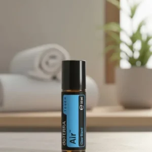 Air Touch doTERRA na kamiennej podstawce obok złożonych ręczników spa
