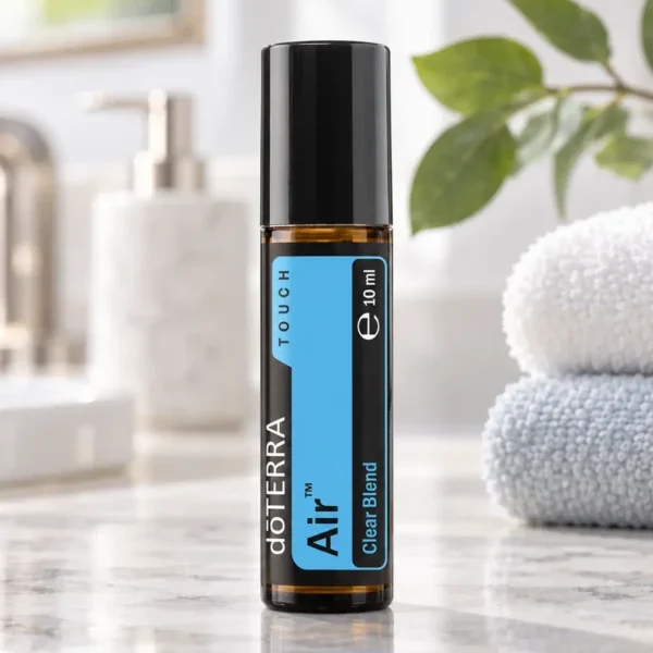 Air Touch doTERRA na kamiennej podstawce obok złożonych ręczników spa