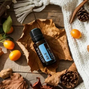 Air-x doTERRA na jesiennej dekoracji z liśćmi i szyszkami