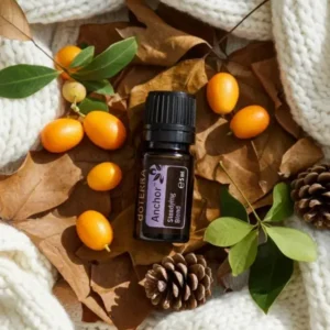Anchor doTERRA na jesiennej dekoracji z liśćmi i szyszkami