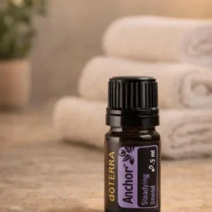 Anchor doTERRA na kamiennej podstawce obok złożonych ręczników spa