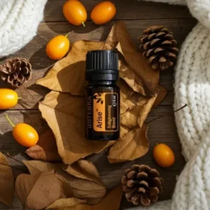 Arise doTERRA na jesiennej dekoracji z liśćmi i szyszkami