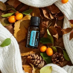 Aromatouch doTERRA na jesiennej dekoracji z liśćmi i szyszkami
