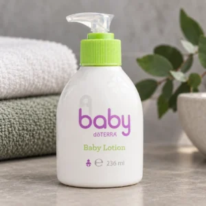 Butelka balsamu doTERRA baby na kamiennym blacie w łazience obok ręczników