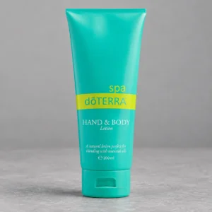 Tuba balsamu doTERRA SPA do rąk i ciała na szarym betonowym blacie