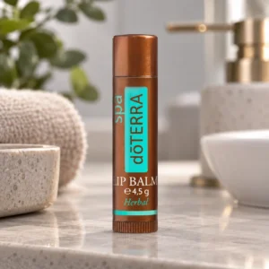 Sztyft balsamu do ust doTERRA SPA na blacie w łazience obok umywalki