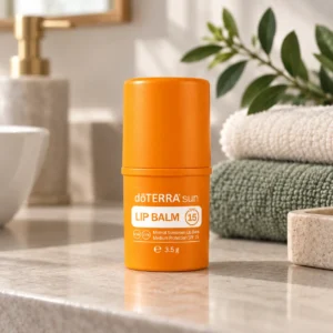 Balsam do ust z filtrem doTERRA sun na blacie w łazience obok ręczników