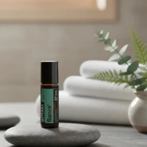 Balance Touch doTERRA na kamiennej podstawce obok złożonych ręczników spa