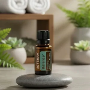 Balance doTERRA na kamiennej podstawce obok złożonych ręczników spa