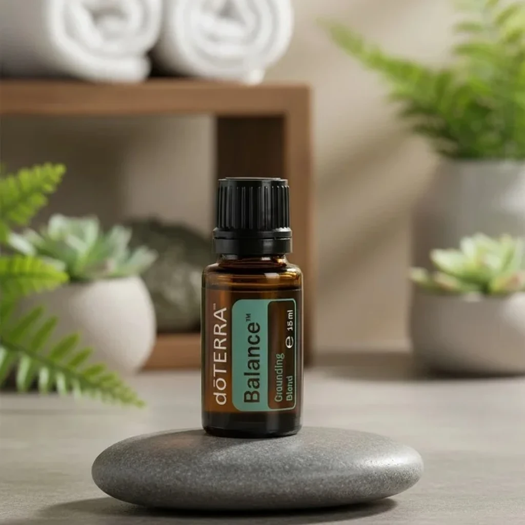 Balance doTERRA na kamiennej podstawce obok złożonych ręczników spa