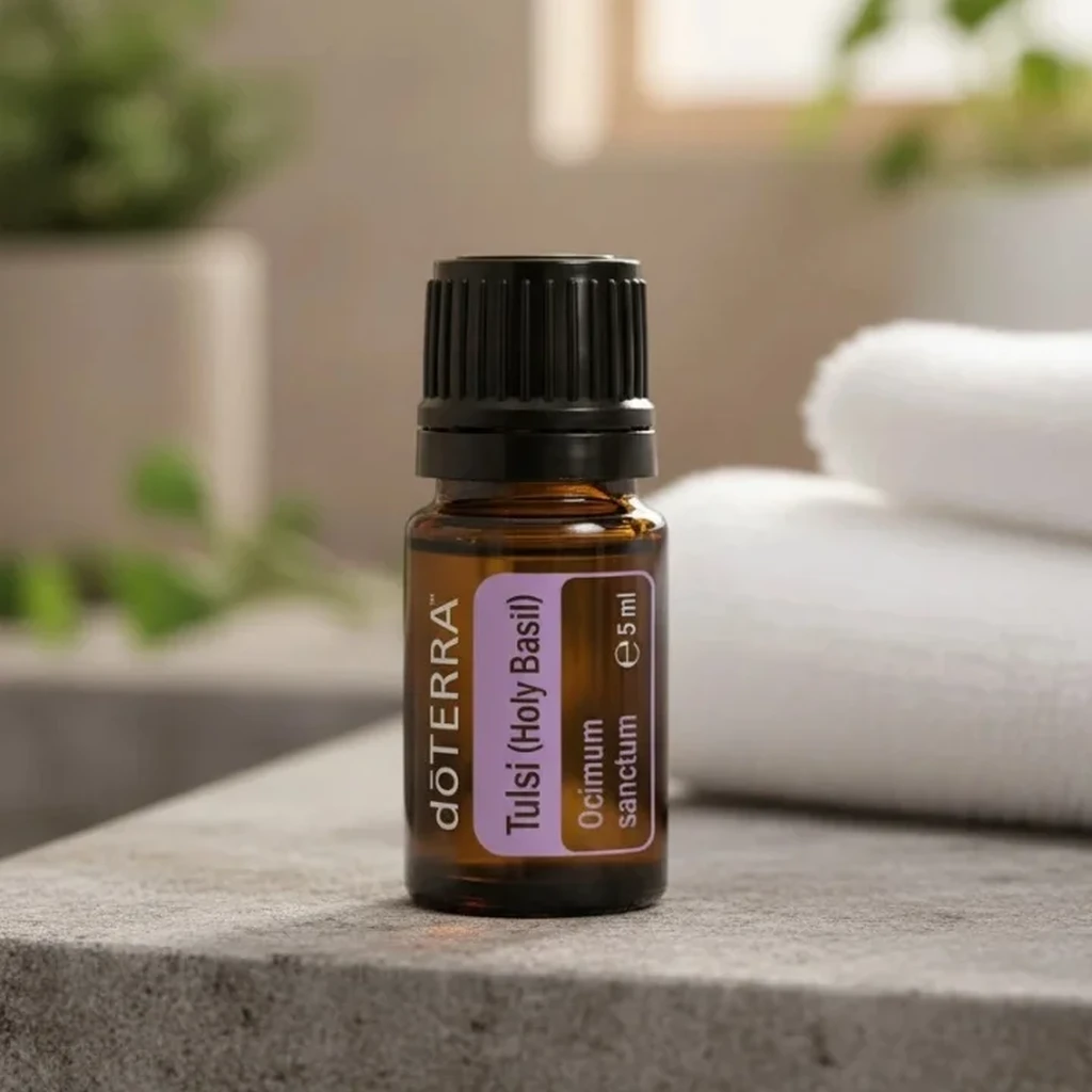 Bazylia Azjatycka (tulsi) doTERRA na kamiennej podstawce obok złożonych ręczników spa