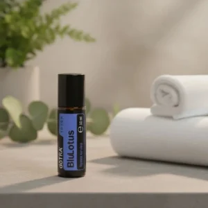 Blue Lotus Touch doTERRA na kamiennej podstawce obok złożonych ręczników spa