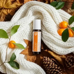 Brave doTERRA na jesiennej dekoracji z liśćmi i szyszkami