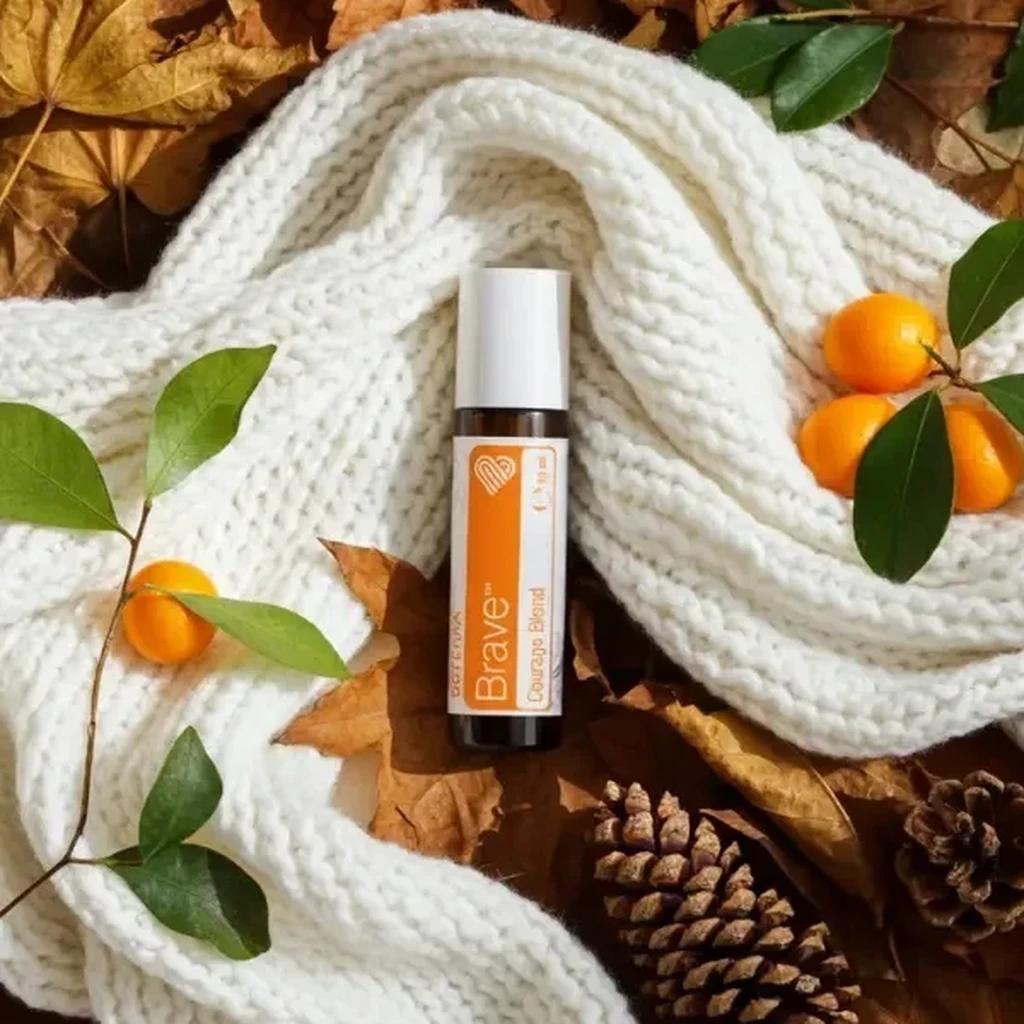 Brave doTERRA na jesiennej dekoracji z liśćmi i szyszkami