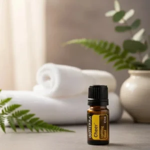 Cheer doTERRA na kamiennej podstawce obok złożonych ręczników spa