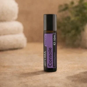 Console Touch doTERRA na kamiennej podstawce obok złożonych ręczników spa