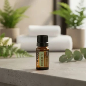 Daglezja doTERRA na kamiennej podstawce obok złożonych ręczników spa