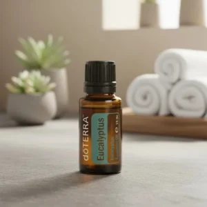 Eukaliptus doTERRA na kamiennej podstawce obok złożonych ręczników spa