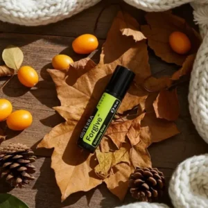 Forgive Touch doTERRA na jesiennej dekoracji z liśćmi i szyszkami