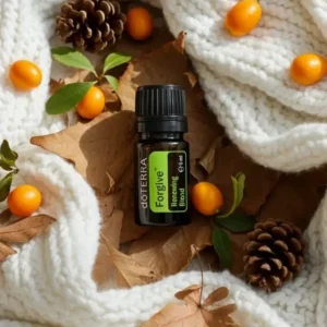 Forgive doTERRA na jesiennej dekoracji z liśćmi i szyszkami