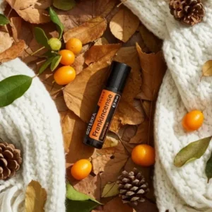 Frankincense Touch doTERRA na jesiennej dekoracji z liśćmi i szyszkami