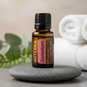 Geranium doTERRA na kamiennej podstawce obok złożonych ręczników spa