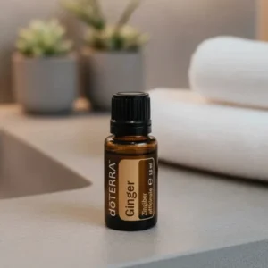 Imbir doTERRA na kamiennej podstawce obok złożonych ręczników spa