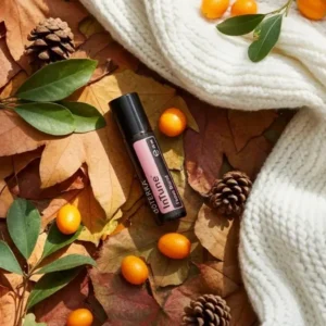 Intune doTERRA na jesiennej dekoracji z liśćmi i szyszkami