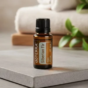 Jodła Syberyjska doTERRA na kamiennej podstawce obok złożonych ręczników spa