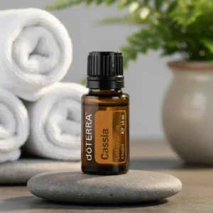 Kasja doTERRA na kamiennej podstawce obok złożonych ręczników spa