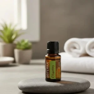 Kolendra (nać) doTERRA na kamiennej podstawce obok złożonych ręczników spa