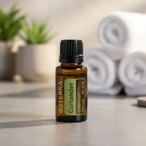 Kolendra (nasiona) doTERRA na kamiennej podstawce obok złożonych ręczników spa