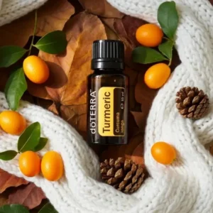 Kurkuma doTERRA na jesiennej dekoracji z liśćmi i szyszkami