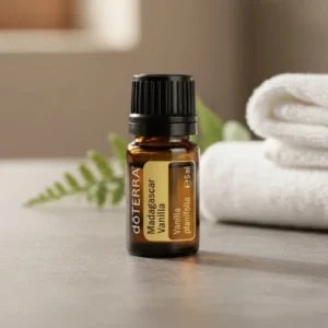 Madagaskarska Wanilia doTERRA na kamiennej podstawce obok złożonych ręczników spa