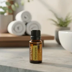 Majeranek doTERRA na kamiennej podstawce obok złożonych ręczników spa