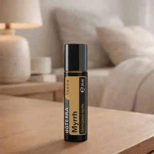 Dłonie trzymające Myrrh Touch doTERRA – aplikacja olejku