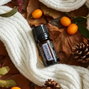 Nard doTERRA na jesiennej dekoracji z liśćmi i szyszkami