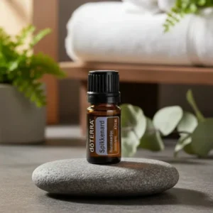 Nard doTERRA na kamiennej podstawce obok złożonych ręczników spa