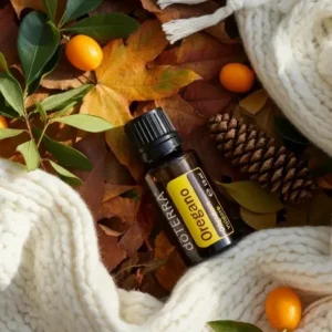 Oregano doTERRA na jesiennej dekoracji z liśćmi i szyszkami