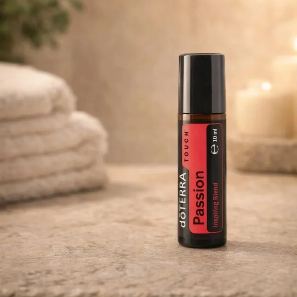 Passion Touch doTERRA na kamiennej podstawce obok złożonych ręczników spa