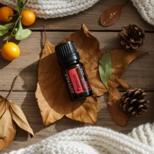 Passion doTERRA na jesiennej dekoracji z liśćmi i szyszkami