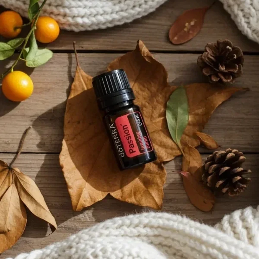 Passion doTERRA na jesiennej dekoracji z liśćmi i szyszkami
