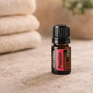 Passion doTERRA na kamiennej podstawce obok złożonych ręczników spa
