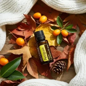 Petitgrain doTERRA na jesiennej dekoracji z liśćmi i szyszkami
