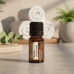 Rumianek Rzymski doTERRA na kamiennej podstawce obok złożonych ręczników spa
