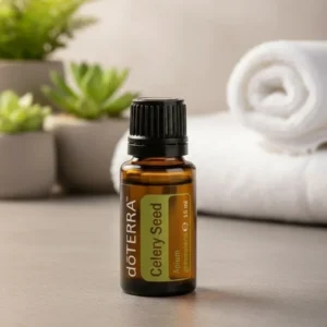 Seler (nasiona) doTERRA na kamiennej podstawce obok złożonych ręczników spa
