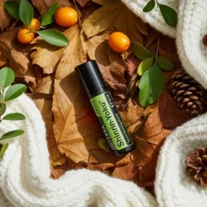 Shinrin-yoku Touch doTERRA na jesiennej dekoracji z liśćmi i szyszkami