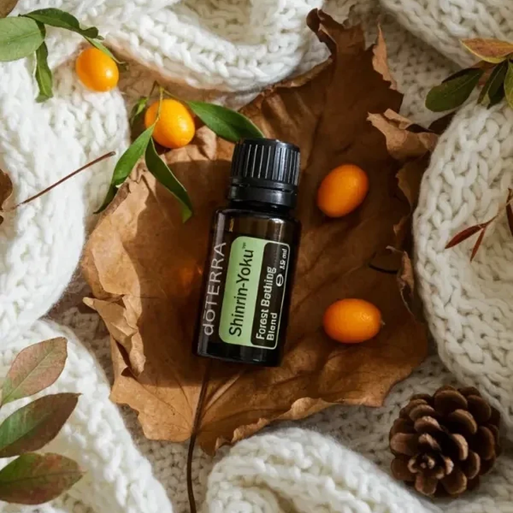 Shinrin-yoku doTERRA na jesiennej dekoracji z liśćmi i szyszkami